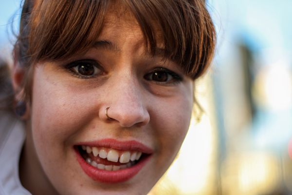 girl with a ring in her nose  and showing gaps in her front teeth